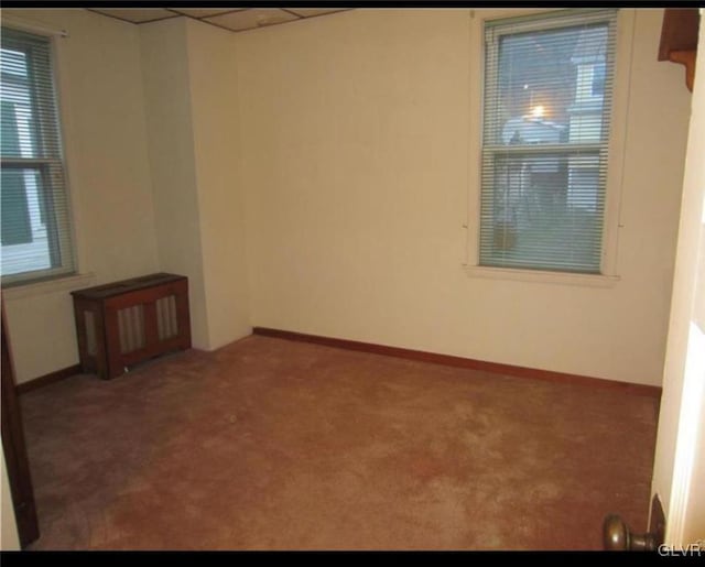 unfurnished room with dark carpet