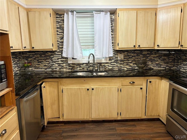 kitchen featuring dark stone counters, stainless steel appliances, sink, backsplash, and dark hardwood / wood-style floors