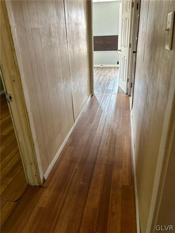 hall with hardwood / wood-style flooring