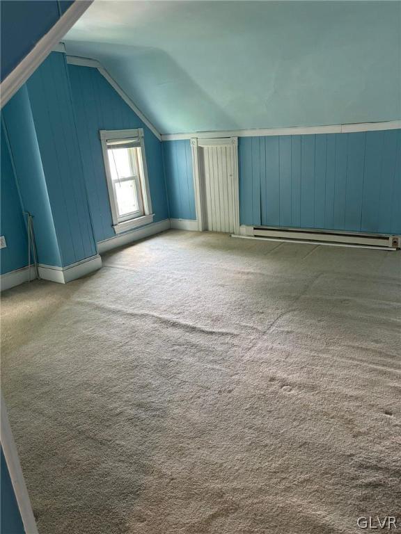 bonus room with carpet floors, baseboard heating, and lofted ceiling