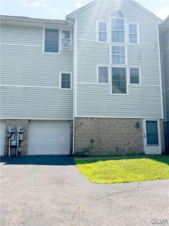 view of side of home featuring a garage