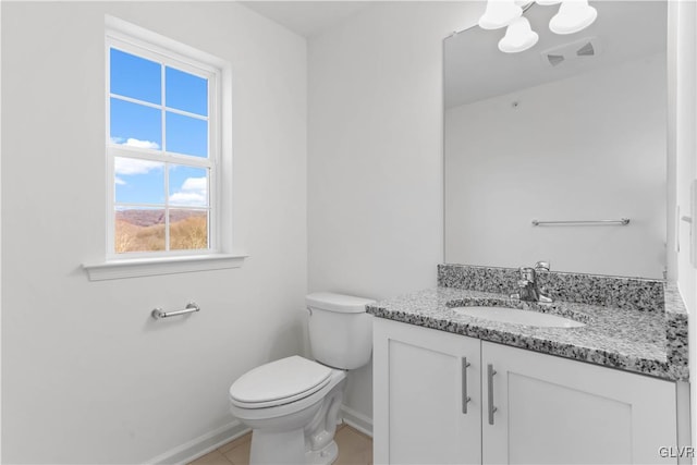 bathroom featuring tile patterned floors, vanity, and toilet