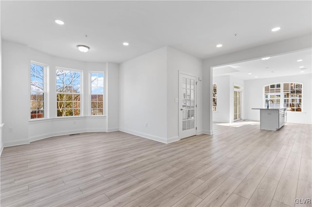 unfurnished living room featuring light wood-type flooring