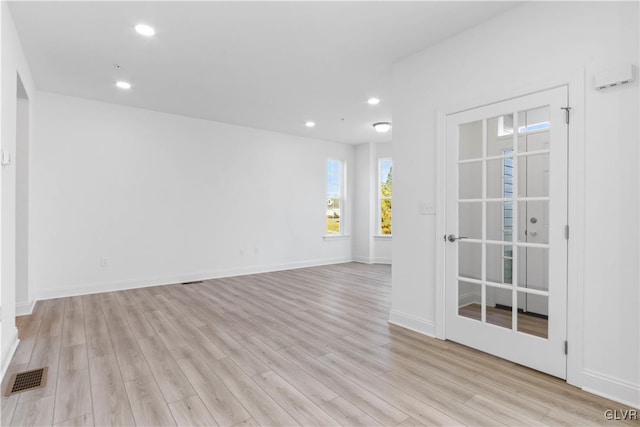 unfurnished room with light hardwood / wood-style flooring