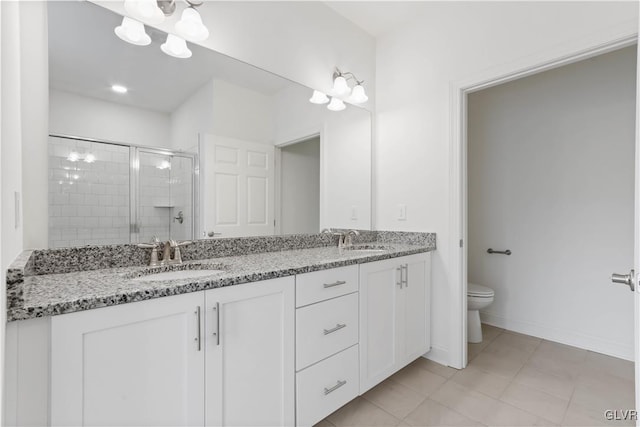 bathroom with tile patterned floors, vanity, toilet, and walk in shower