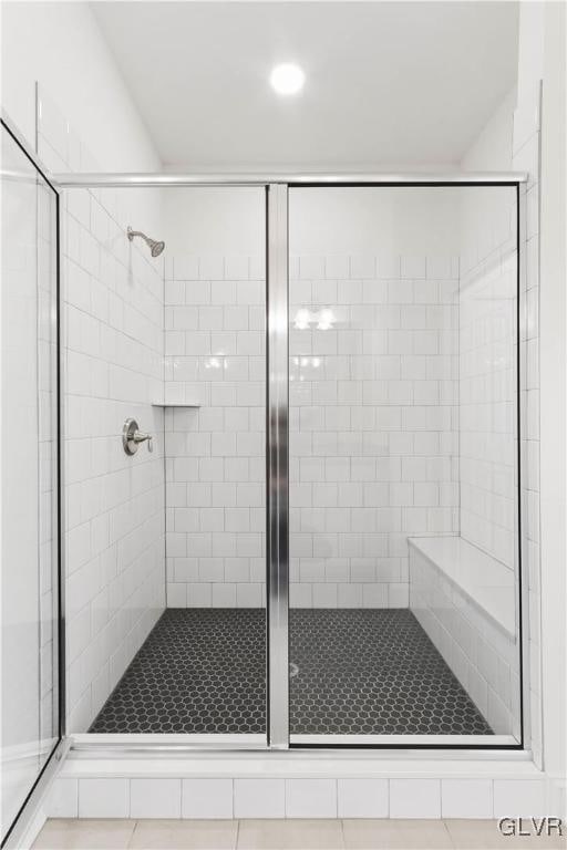 bathroom with tile patterned flooring and an enclosed shower