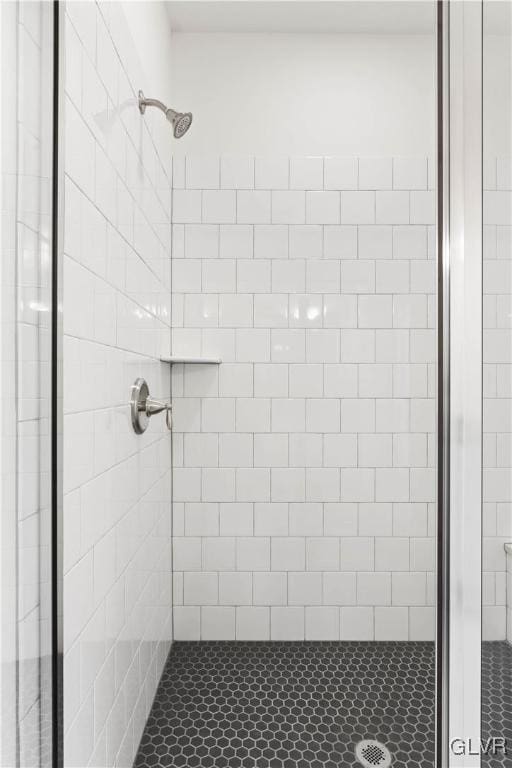 bathroom with tiled shower