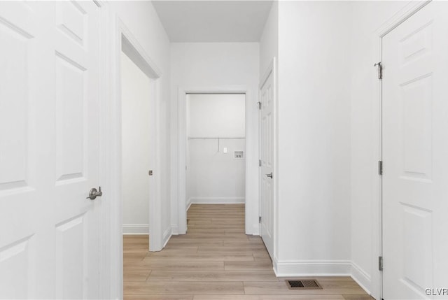 corridor with light wood-type flooring