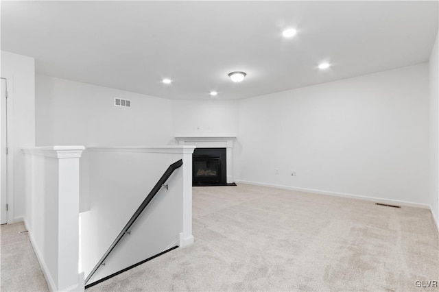 unfurnished living room with light carpet