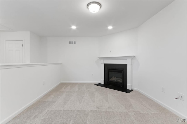 unfurnished living room featuring light carpet