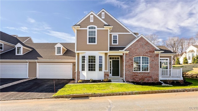 view of front of home with a front lawn and a garage