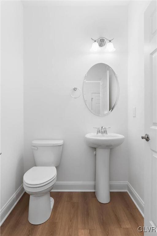 bathroom with toilet and wood-type flooring