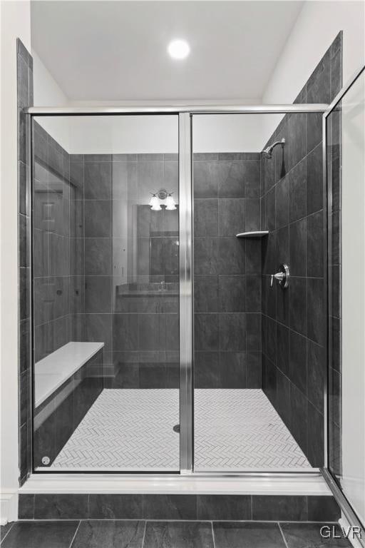 bathroom featuring tile patterned flooring and an enclosed shower