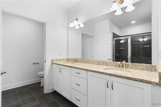 bathroom with tile patterned floors, a shower with door, vanity, and toilet