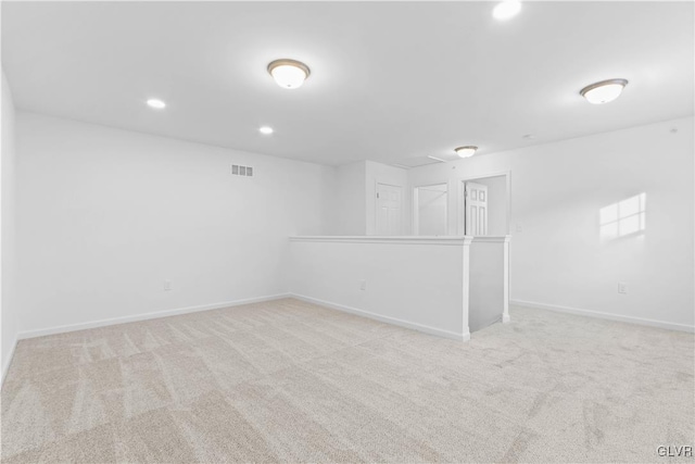 unfurnished room with light colored carpet