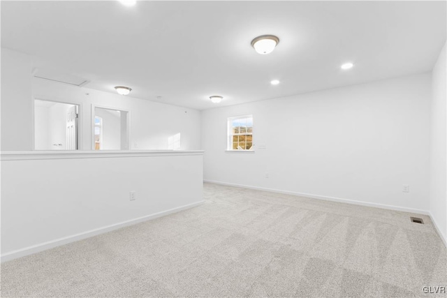 unfurnished room featuring light colored carpet