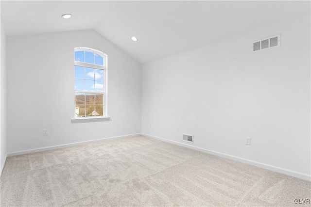 bonus room with lofted ceiling and light carpet