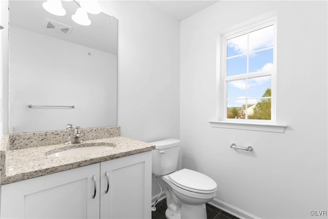 bathroom featuring tile patterned floors, vanity, and toilet