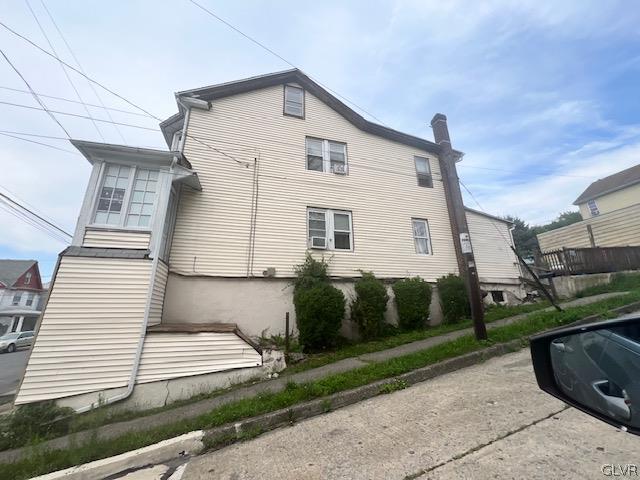 view of side of home featuring a chimney