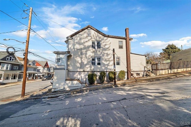 exterior space with a chimney and fence