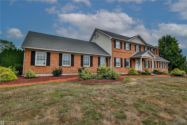 colonial home with a front lawn