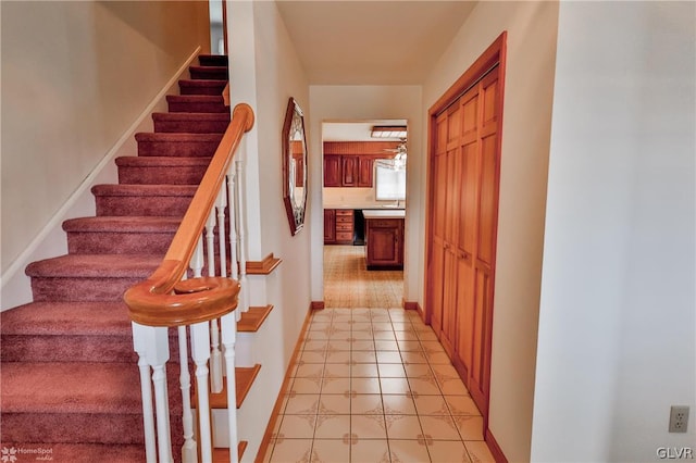 stairway with light tile patterned floors