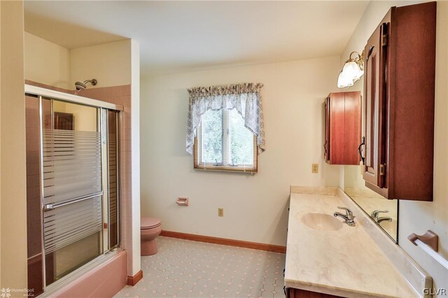 bathroom featuring tile patterned flooring, toilet, and vanity