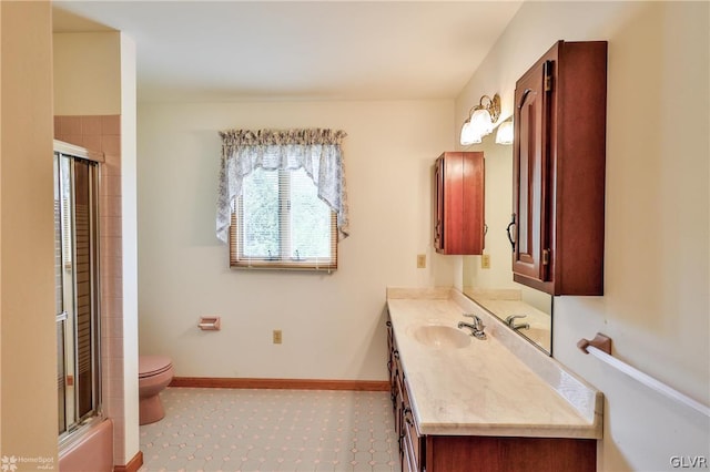 bathroom featuring vanity, tile patterned floors, and toilet