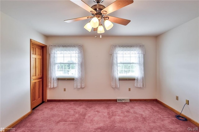 empty room featuring carpet flooring, a healthy amount of sunlight, and ceiling fan