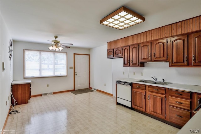 kitchen with sink, white dishwasher, light tile patterned floors, and ceiling fan