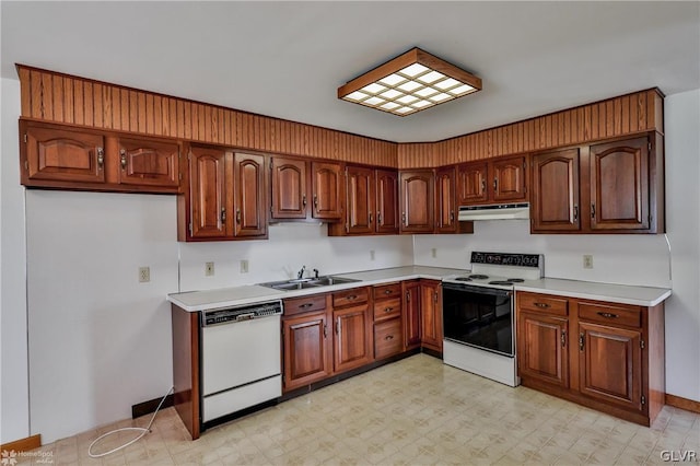 kitchen with sink, light tile patterned floors, and white appliances