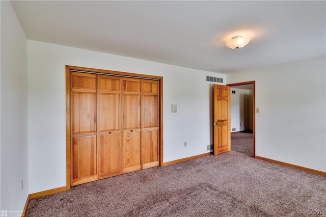 unfurnished bedroom with a closet and carpet flooring