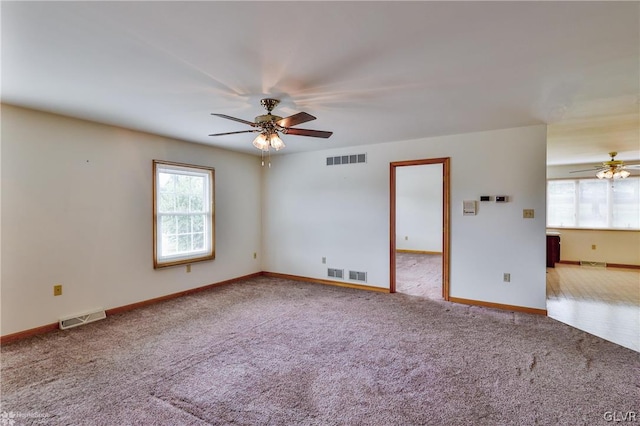 carpeted spare room with ceiling fan