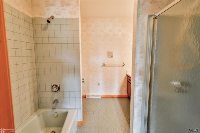 bathroom with tile patterned floors, vanity, and enclosed tub / shower combo