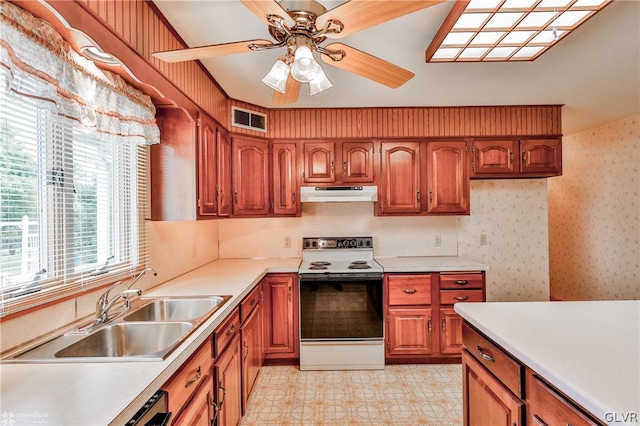 kitchen featuring sink, ceiling fan, white electric range oven, and light tile patterned floors