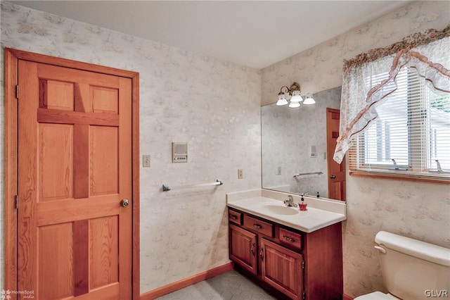 bathroom featuring vanity, toilet, and tile patterned flooring