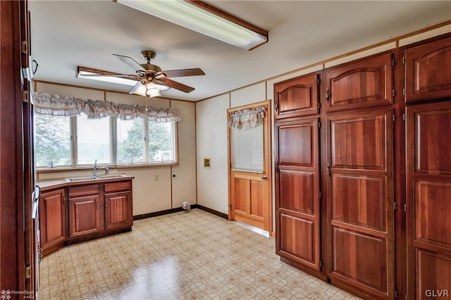 kitchen featuring light tile patterned flooring, sink, and ceiling fan