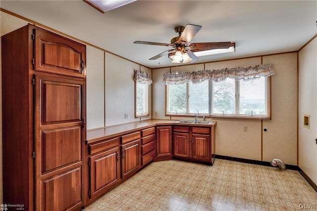 kitchen featuring sink, light tile patterned flooring, and ceiling fan