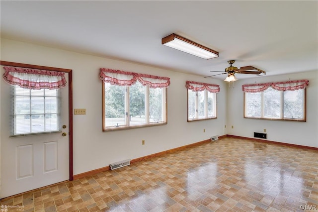 foyer entrance with light tile patterned floors, ceiling fan, and plenty of natural light