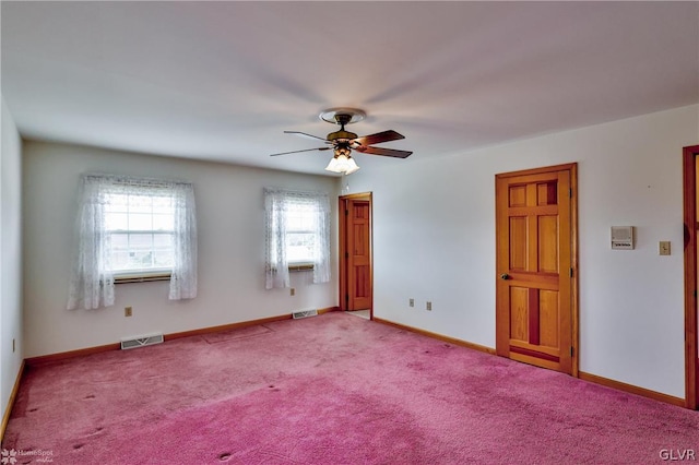 carpeted spare room with ceiling fan