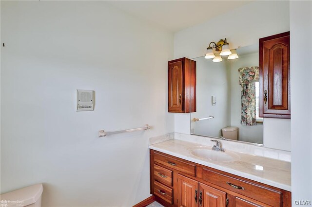 bathroom featuring vanity and toilet