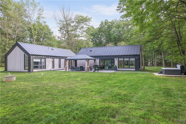 back of house with a lawn and a patio area