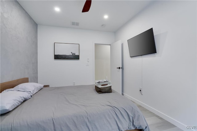 bedroom with ceiling fan and light hardwood / wood-style flooring