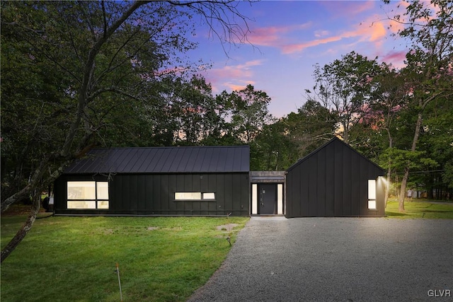 outdoor structure at dusk featuring a lawn