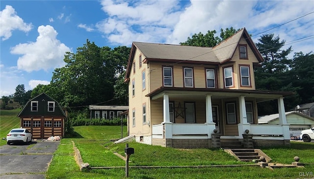 view of front of home featuring a porch, a garage, and a front lawn