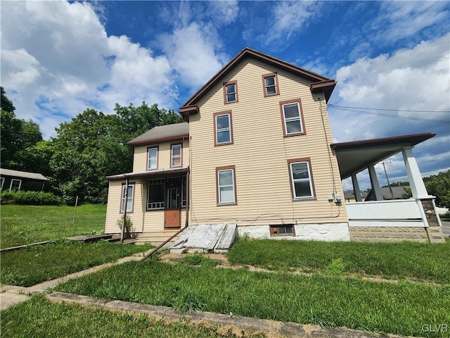 rear view of house with a yard