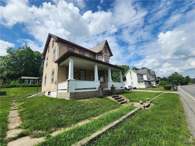 view of front of home with a porch and a front lawn