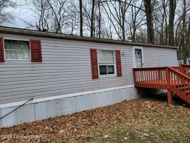 view of side of home featuring a deck