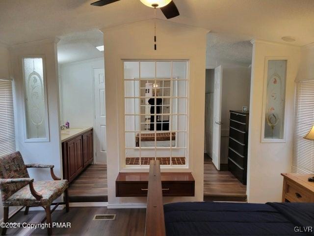 interior space with dark wood-type flooring, ceiling fan, and lofted ceiling