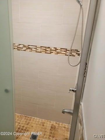 bathroom with tiled shower